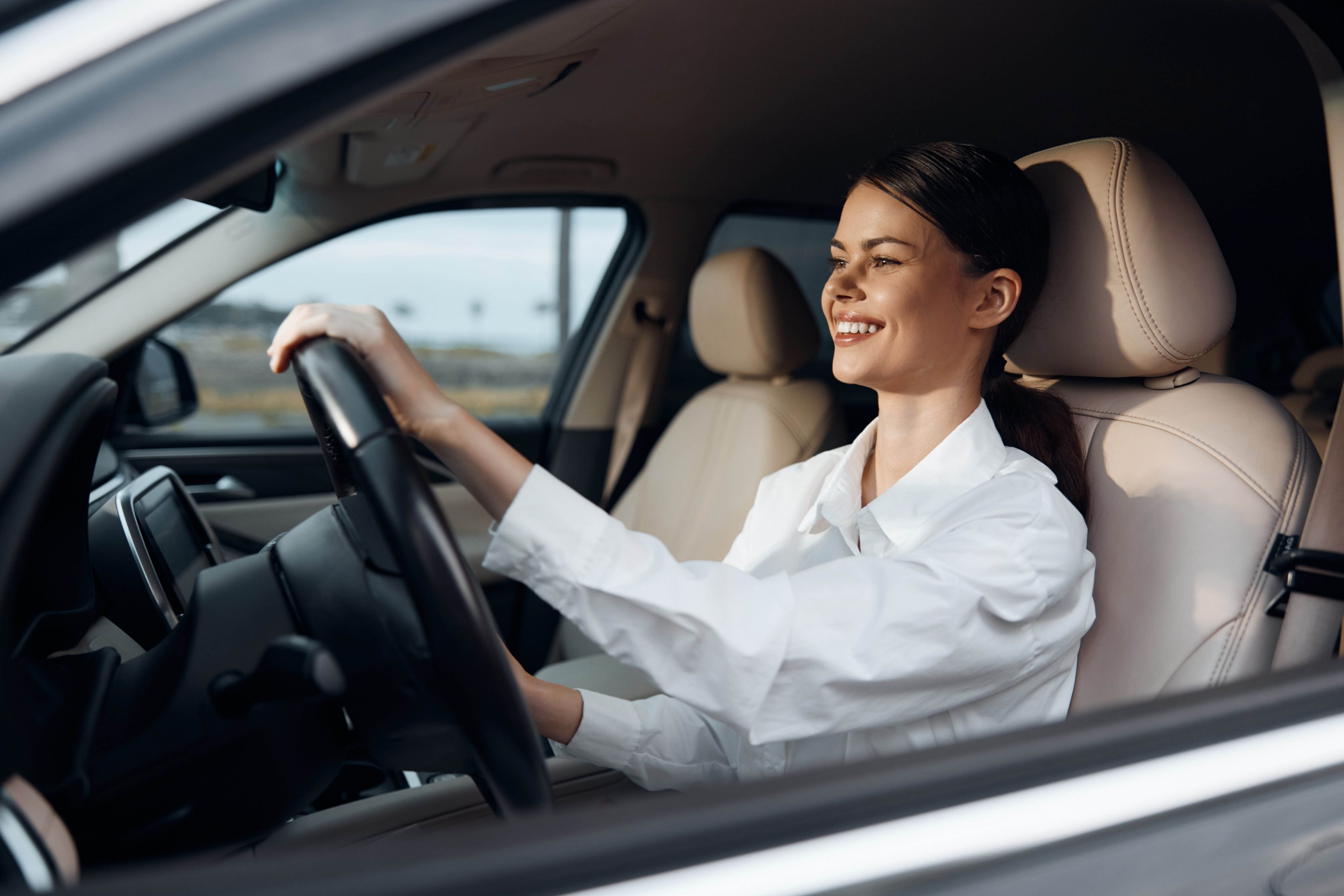 Motorista dirigindo seu carro e sorrindo        