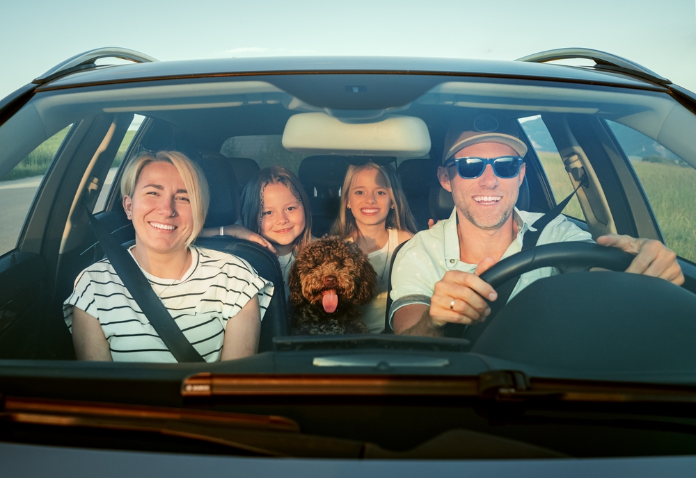 Família feliz dentro do carro