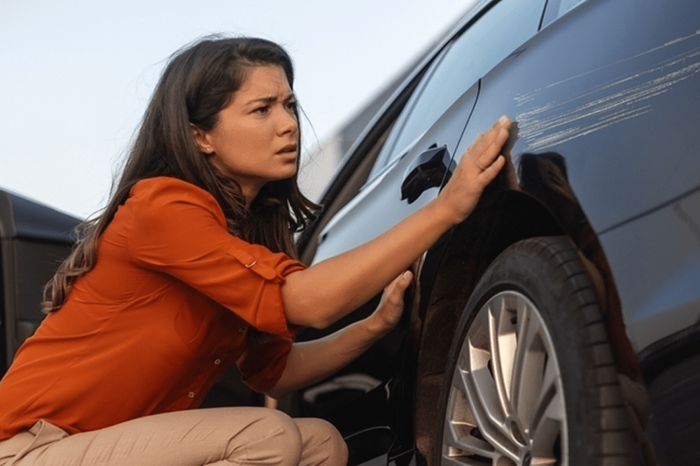 Mulher preocupada após batida de carro