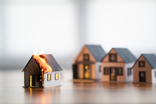 miniatura de casa pegando fogo representando seguro de casa