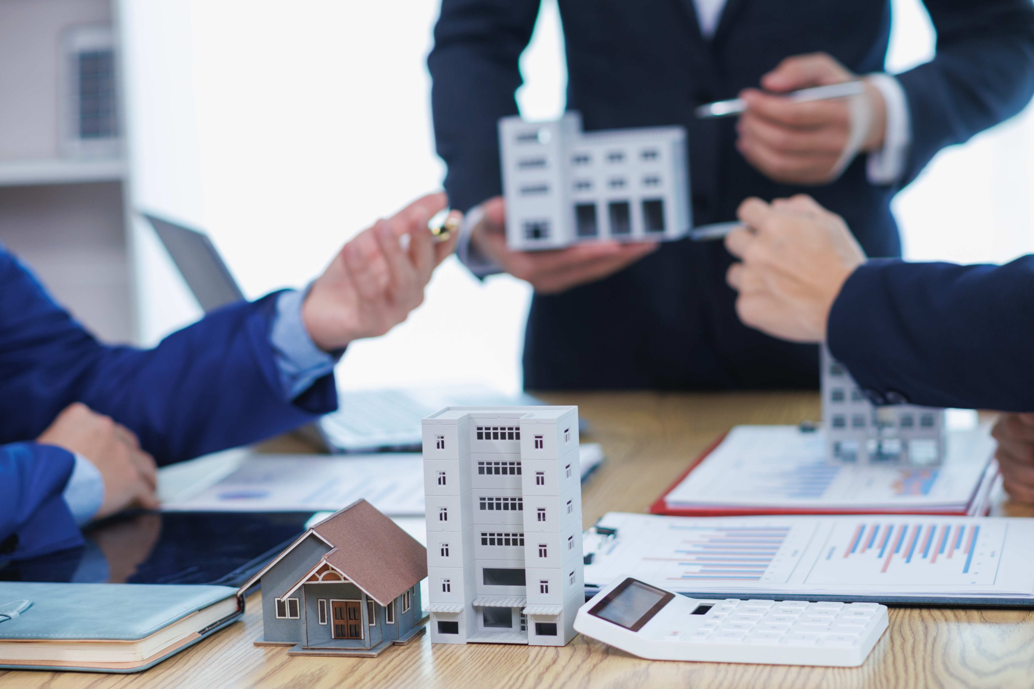 Três homens em uma mesa debatendo sobre seguros