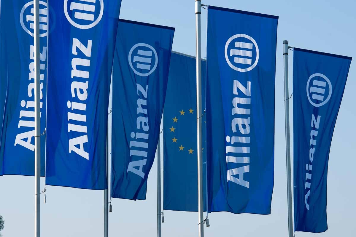Bandeiras da Allianz exibidas em área externa, reforçando a posição da companhia como a marca de seguros mais valiosa do mercado.