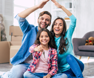 Família posando para foto após a realização da compra de um imóvel