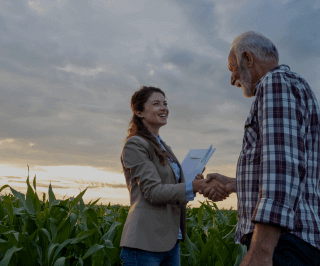 Corretora da Allianz apertando a mão de um senhor fazendeiro